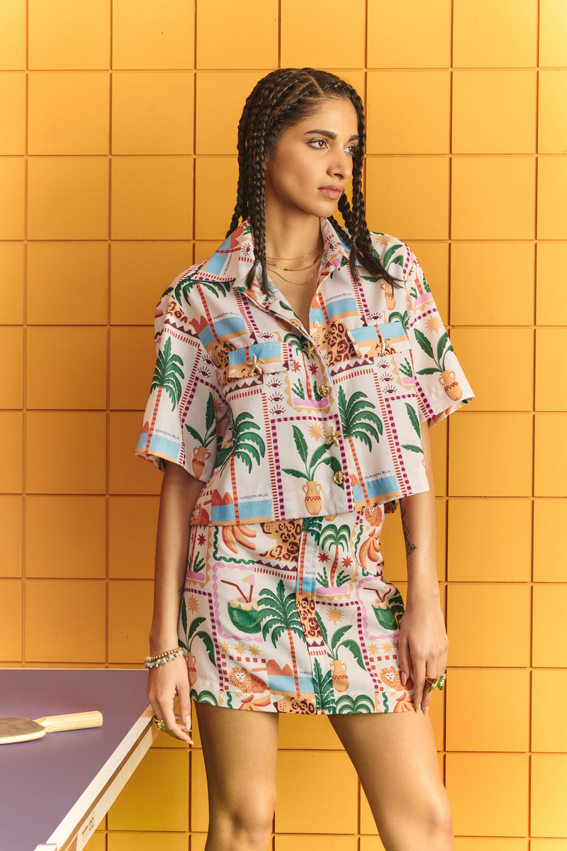 Crop shirt with bold statement buttons with short skirt