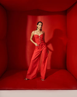 Red corset crop with bold statement buttons with flare pants tube