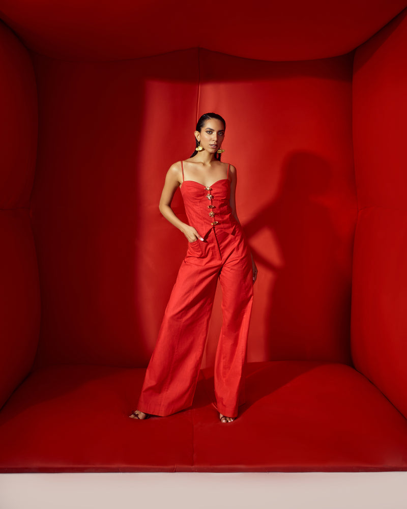 Red corset crop with bold statement buttons with flare pants tube
