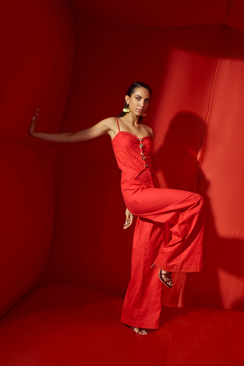 Red corset crop with bold statement buttons with flare pants tube