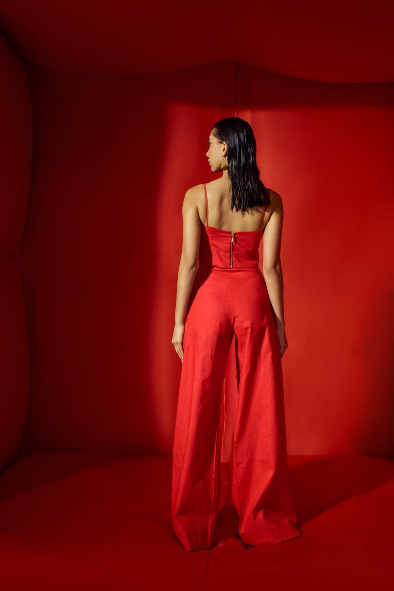 Red corset crop with bold statement buttons with flare pants tube